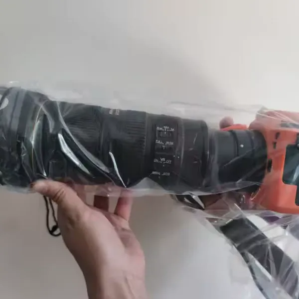 Rainskin clear cover over a Nikon body and a large telephoto lens, photographed by a verified buyer